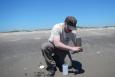 A USFWS biologist takes samples of sand at North Breton Island.