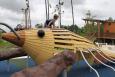 The park’s architect integrated the crayfish into the theme and design of the park by placing a climbing structure resembling a giant crayfish in a prominent spot in the children’s playground. (Credit: Trust for Public Lands) a boy sits above a crayfish climber at a park