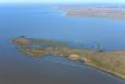 an aerial shot of land surrounded by low tide