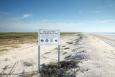 Sign with project information in front of a restored beach in Texas.