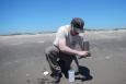 A USFWS biologist takes samples of sand at North Breton Island.