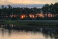 Sunset over a forested Mississippi coastal waterway.