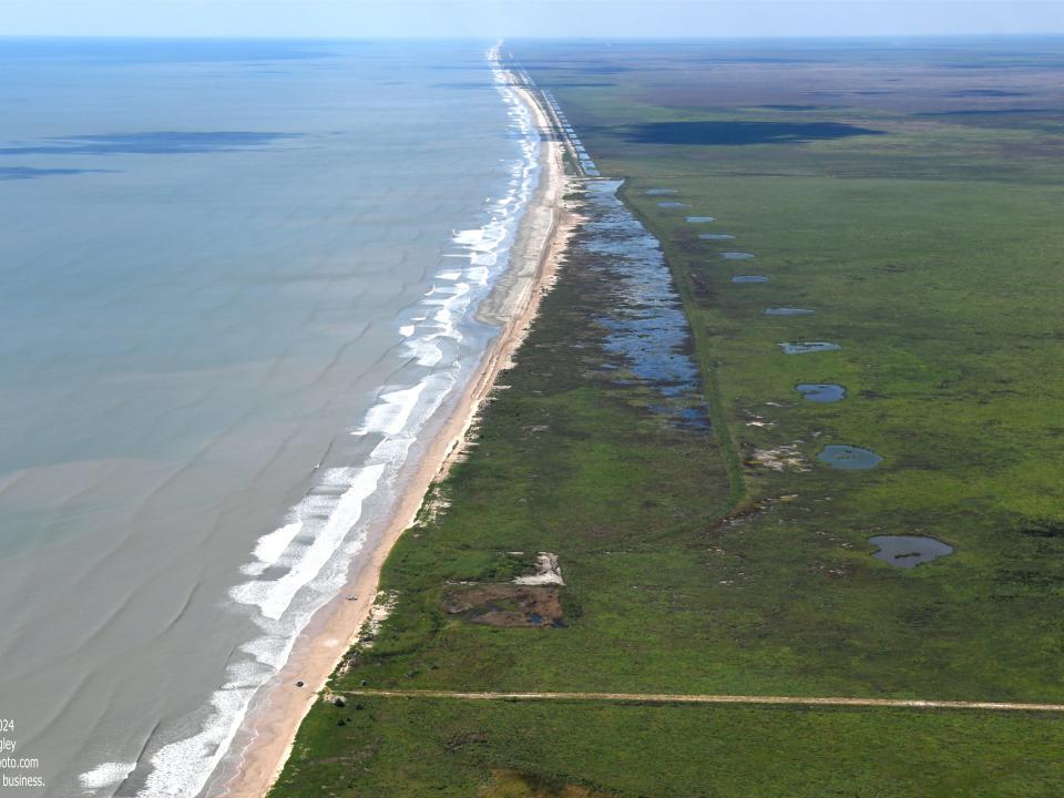 More than 14 miles of beaches and dunes were restored using sediments pumped from offshore borrow areas. (Photo: Patrick M. Quigley) an aerial of mcfadden beach's shoreline