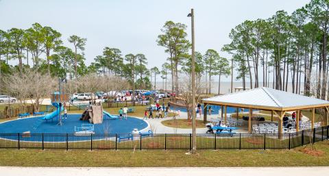 a kid's playground with people milling about