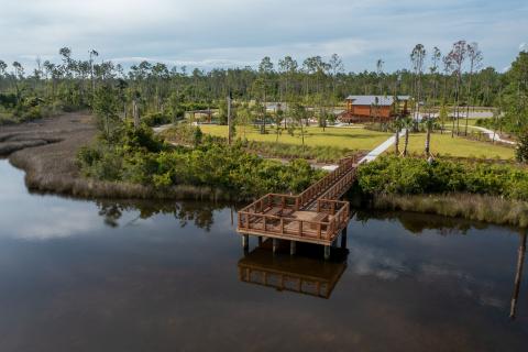 Aerial image of a park and recreational pier jetting out into a bay in the Gulf of Mexico.