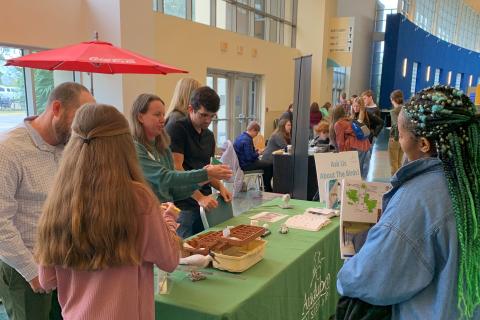 People at a table learn about Mississippi restoration activities at an Annual Meeting. 