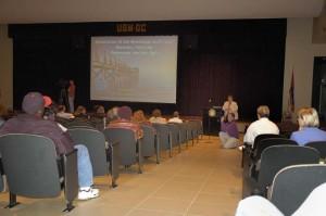A person presents in front of an auditorium