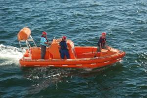 Three people on an orange power boat