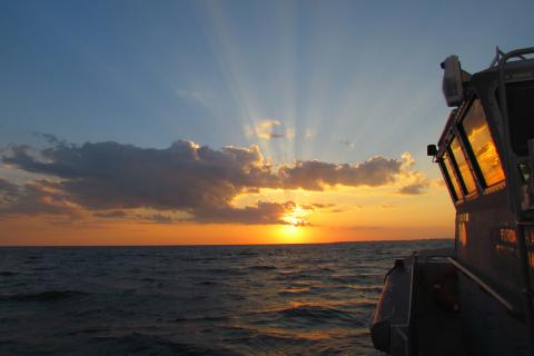 View of the sun setting over the Gulf of Mexico from a vessel.